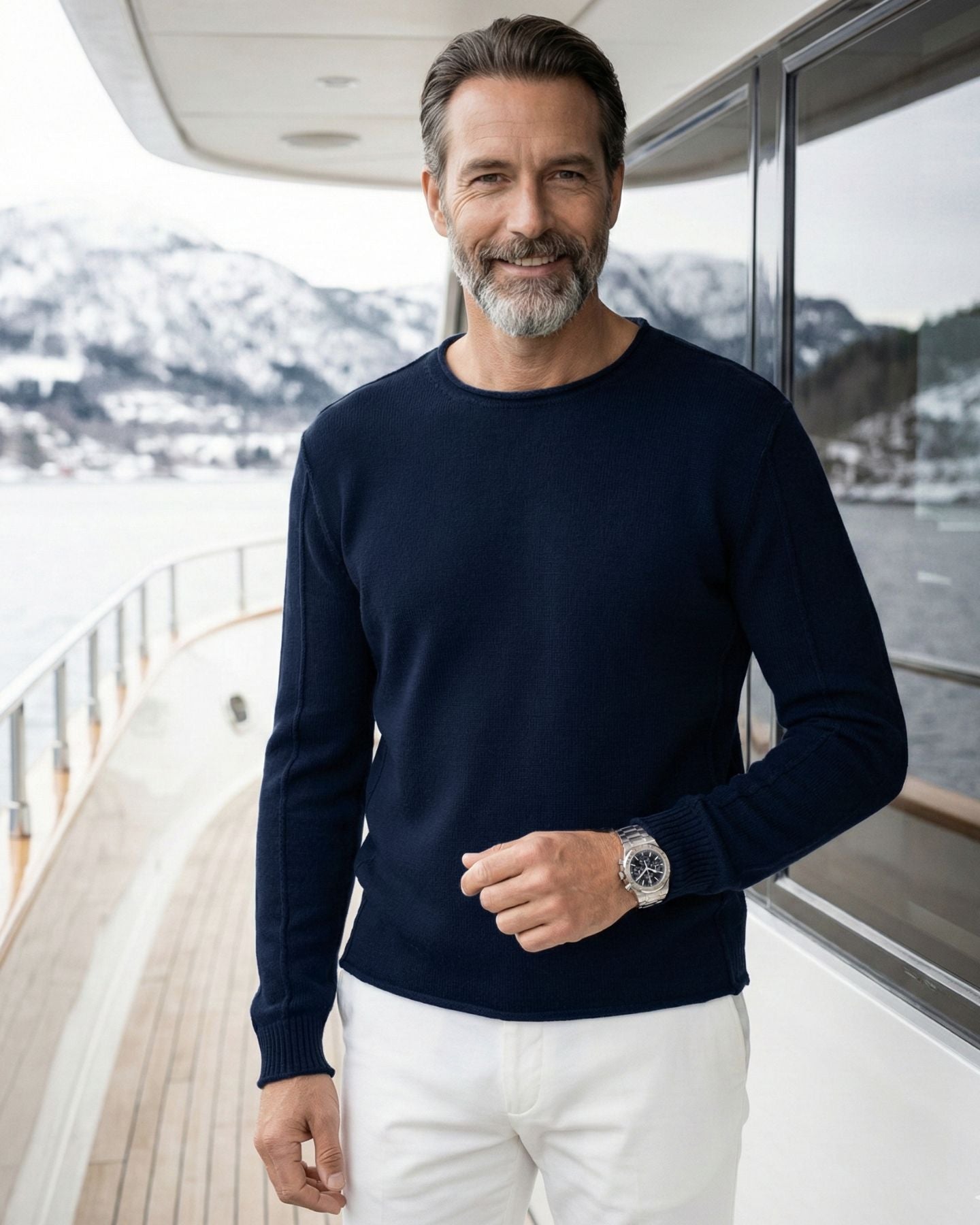 Man in navy colored Cashmere Premium Roundneck sweater standing on the yacht